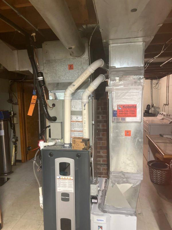 Completed full HVAC system installation in basement mechanical room, including new furnace unit with modern high-efficiency cabinet design, proper venting configuration with PVC exhaust piping, and connection to existing ductwork infrastructure. Verified level installation of thermostat control and ensured all components met manufacturer specifications and local code requirements.