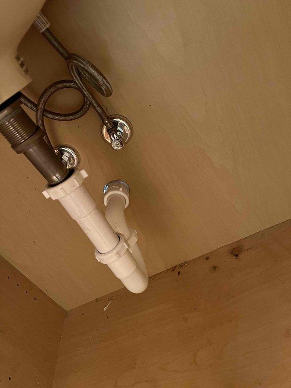 Accessed plumbing system through closet wall by cutting drywall access panel to expose corroded copper supply lines. Replaced deteriorated copper piping with new copper pipe and fittings, installed chrome shut-off valves, and connected braided stainless steel flexible supply lines to fixture. Verified proper water flow and tested all connections for leaks before completing installation.