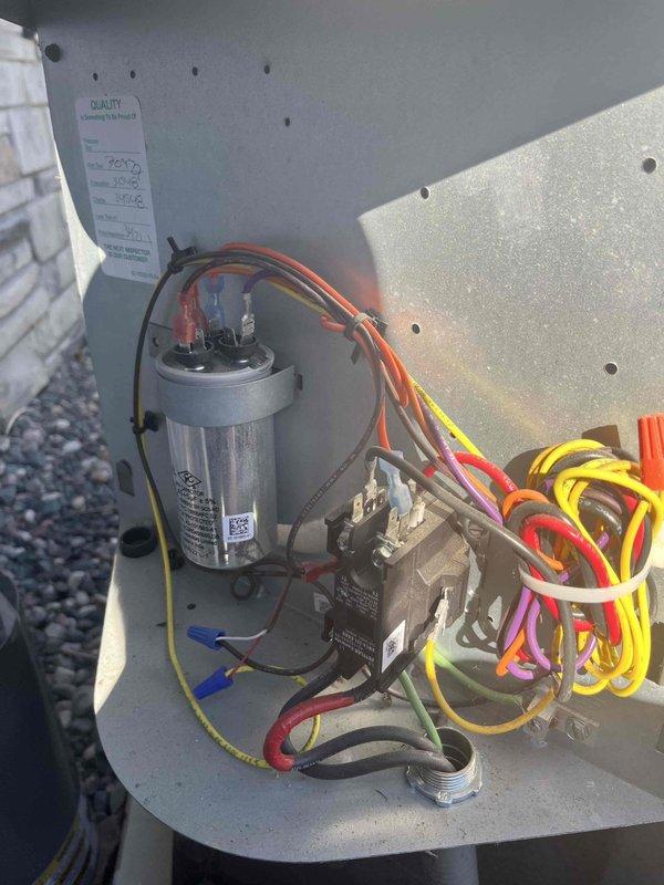 Responded to no cooling complaint on residential split system air conditioning unit. Upon arrival, found outdoor condensing unit operational but system not achieving adequate cooling performance. Inspected electrical compartment and identified failed run capacitor causing compressor to operate inefficiently. Replaced defective capacitor with proper OEM-rated replacement, verified all electrical connections secure, and tested system operation. Unit now cooling properly with normal temperature differential and amperage readings within manufacturer specifications.