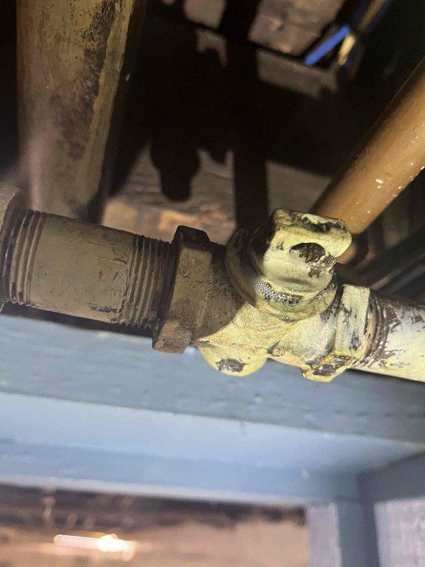 Returned to property to complete previously sold repair work on 2-inch gas line. Cut open existing deteriorated gas piping at corroded junction point showing significant age-related degradation and buildup. Installed press coupling connection and new 2-inch 90-degree elbow fitting to restore proper gas line configuration. All connections secured and system restored to safe operating condition.