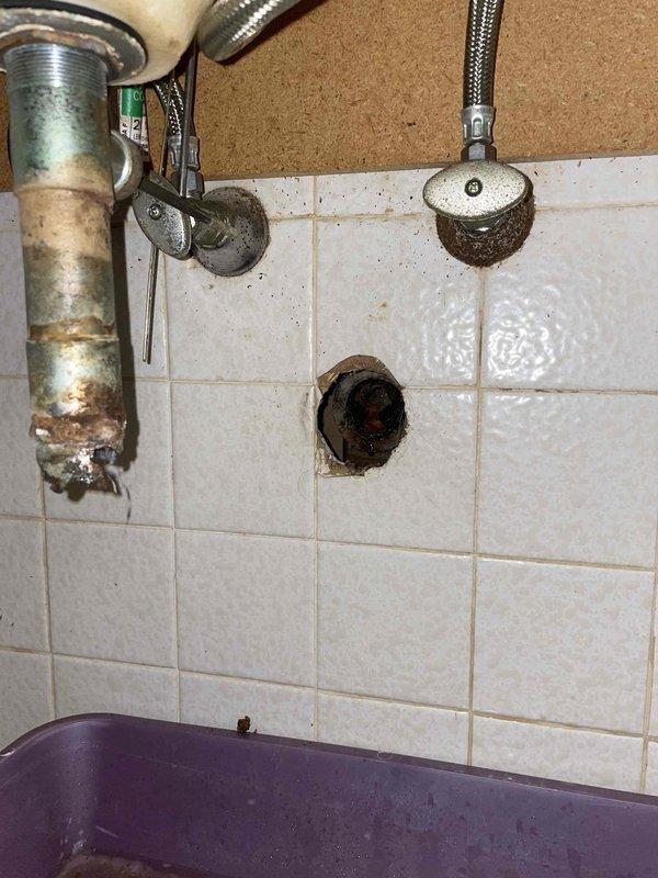 Responded to service call for clogged bathroom sink and laundry drain. Upon inspection, discovered severely corroded and deteriorated drain piping behind bathroom wall fixture requiring immediate replacement. Removed failed pipe section which exhibited extensive internal buildup, corrosion, and structural degradation that was causing drainage issues. The compromised piping showed heavy scale accumulation and complete breakdown of interior lining material. Replaced damaged section with new piping to restore proper drainage function to both affected fixtures.