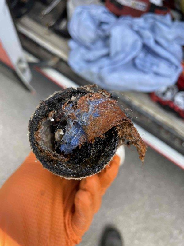 Responded to service call for clogged bathroom sink and laundry drain. Upon inspection, discovered severely corroded and deteriorated drain piping behind bathroom wall fixture requiring immediate replacement. Removed failed pipe section which exhibited extensive internal buildup, corrosion, and structural degradation that was causing drainage issues. The compromised piping showed heavy scale accumulation and complete breakdown of interior lining material. Replaced damaged section with new piping to restore proper drainage function to both affected fixtures.