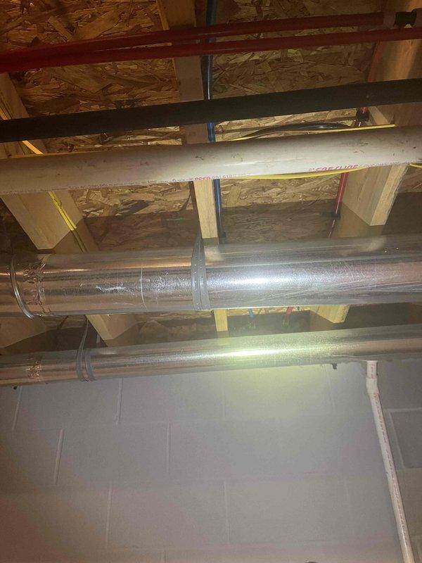 Completed free estimate for garage sink installation requiring new drain line and water supply rerouting. Assessed existing ceiling-mounted plumbing infrastructure including PVC drain lines, copper water supply lines, and utility routing through exposed joists. Evaluated basement access points and existing mechanical systems to determine optimal path for extending water supply and establishing proper drainage connection to main waste line.