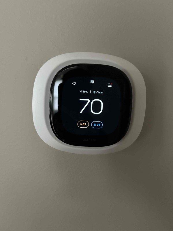 Completed comprehensive AC tune-up and preventative maintenance on residential air conditioning system. System found operating within normal parameters with no reported issues or concerns. Performed standard inspection of air handler unit, verified electrical connections and components, checked refrigerant lines and condensate management, and confirmed thermostat functionality displaying proper temperature control at 70 degrees.