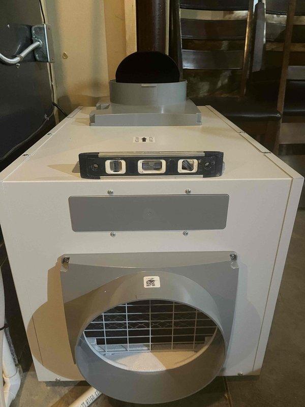Completed installation of whole home dehumidifier system in basement utility area. Unit was mounted and integrated with existing HVAC infrastructure, including connection of refrigerant lines, PVC drainage piping, and electrical controls. System tested and operational upon departure.