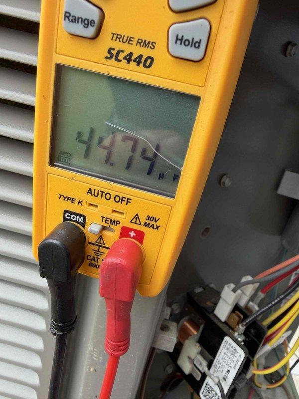 Completed comprehensive HVAC tune-up service including system diagnostics and component inspection. Performed electrical measurements using digital multimeter, verifying proper voltage readings at 447.4V on system components and testing relay connections. Inspected blower wheel assembly, confirming clean operation with no debris accumulation, proper motor shaft alignment, and all blades intact with no signs of wear or damage.