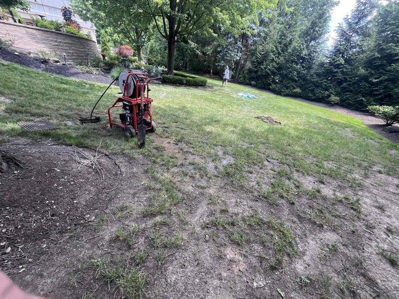 Completed hydro jetting service for main sewer line cleanout. Excavated and accessed underground cleanout point, deployed high-pressure jetting equipment to clear blockage and restore proper drainage flow. Backfilled excavation area and restored ground surface upon completion of cleaning operation.