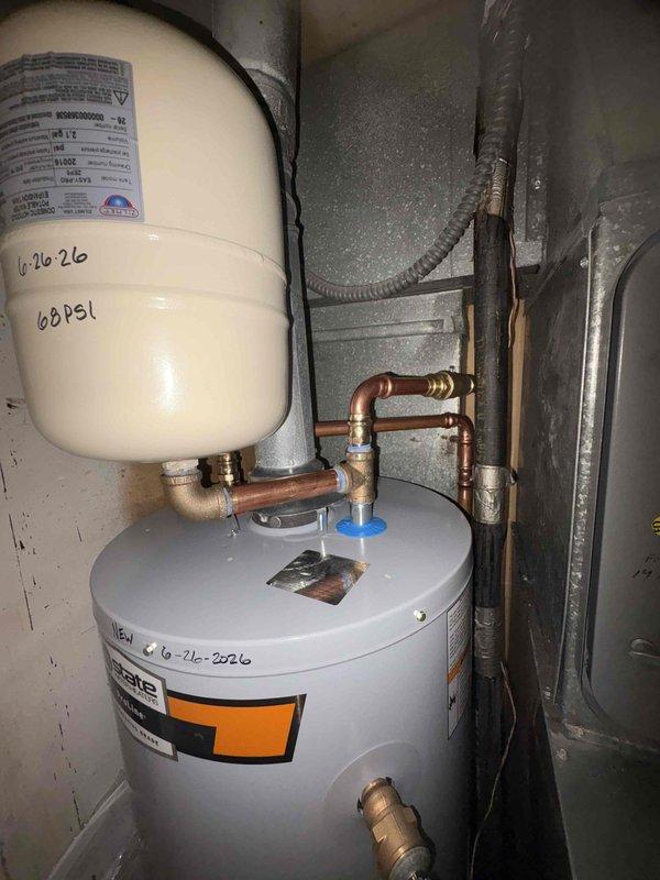Returned to service location to complete installation of 40-gallon blanket-wrapped water heater with expansion tank. Verified all plumbing connections, including copper piping with brass fittings and pressure relief valve. Documented installation with pressure reading of 68 PSI on expansion tank and marked service date on equipment for future reference.
