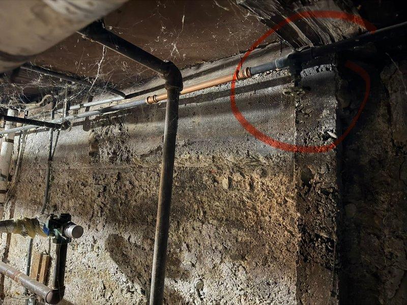 Responded to water leak in basement area at Unit 3. Upon inspection, identified active leak originating from boiler valve assembly. Documented existing conditions including exposed plumbing infrastructure in crawl space with copper and black piping, along with compromised boiler valve showing signs of age and deterioration. Valve exhibited brass stem discoloration and visible wear on chrome body with water damage evident on surrounding carpet flooring. Assessed leak severity and photographed affected areas for documentation purposes.