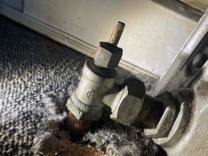 Responded to water leak in basement area at Unit 3. Upon inspection, identified active leak originating from boiler valve assembly. Documented existing conditions including exposed plumbing infrastructure in crawl space with copper and black piping, along with compromised boiler valve showing signs of age and deterioration. Valve exhibited brass stem discoloration and visible wear on chrome body with water damage evident on surrounding carpet flooring. Assessed leak severity and photographed affected areas for documentation purposes.