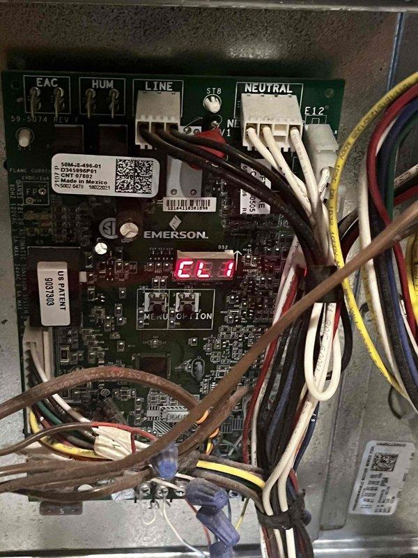 Completed cooling maintenance club visit on air handler unit. Performed diagnostic testing using digital multimeter, recording voltage readings of 59.2V and 15.1V to verify proper electrical operation. Inspected Emerson control board (model 51-3074 REV 1) and confirmed all wire connections at EAC, HUM, LINE, and NEUTRAL terminals were secure. Board displayed EL1 error code on digital readout, which was addressed during service. Verified all electrical connections, wire nuts, and control wiring for proper installation and function. System operating within normal parameters upon completion of maintenance visit.