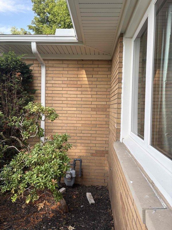 Conducted on-site evaluation for HVAC system replacement to transition from existing baseboard hot water heating to forced air system in select rooms. Assessed exterior unit placement location along brick foundation wall near landscaping area, confirming adequate clearance for condenser installation and service access. Inspected attic space to evaluate existing ductwork infrastructure and determine routing requirements for new supply and return air distribution. Documented current HVAC equipment including silver insulated ductwork, metal plenum box, and flexible duct components to develop comprehensive replacement proposal. Provided estimate for mini-split or ducted system installation to deliver heating and cooling capabilities to designated zones while maintaining existing baseboard system in remaining areas of residence.