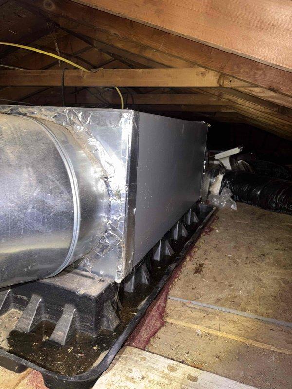 Conducted on-site evaluation for HVAC system replacement to transition from existing baseboard hot water heating to forced air system in select rooms. Assessed exterior unit placement location along brick foundation wall near landscaping area, confirming adequate clearance for condenser installation and service access. Inspected attic space to evaluate existing ductwork infrastructure and determine routing requirements for new supply and return air distribution. Documented current HVAC equipment including silver insulated ductwork, metal plenum box, and flexible duct components to develop comprehensive replacement proposal. Provided estimate for mini-split or ducted system installation to deliver heating and cooling capabilities to designated zones while maintaining existing baseboard system in remaining areas of residence.