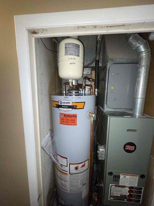 Returned to property to complete water heater replacement and kitchen plumbing rework as previously sold. Successfully installed new State brand water heater with expansion tank, properly connected all copper supply lines and verified system pressurization. Completed kitchen sink drain line rework, replacing deteriorated components with new chrome P-traps and PVC drainage assembly to address existing water damage visible in cabinet base. All connections tested and verified leak-free, systems operational.