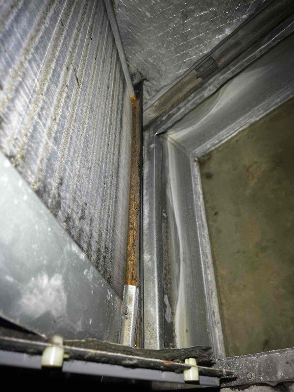 Responded to no cooling call on air handling unit. Upon arrival, found system had been shut off per dispatch instructions due to reported lack of cold air output. Performed visual inspection of indoor unit and discovered significant moisture accumulation and biological growth in condensate drain pan, indicating drainage system compromise. Observed rust formation on internal metal components and dust accumulation throughout air handler cabinet. Insulation material showed normal wear patterns consistent with system age. Documented existing conditions of condensate management system and interior components. Unit requires drain line service and cleaning to restore proper operation and prevent future drainage issues affecting cooling performance.
