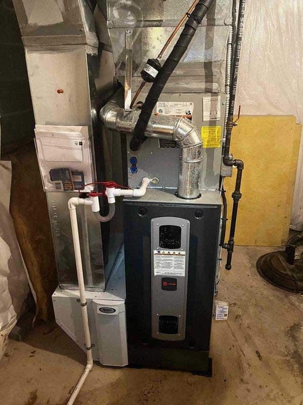 Responded to no cooling complaint on system installed in 2022. Customer reported outdoor fan spinning but no cool air output, suspecting indoor blower malfunction. Upon arrival, inspected both indoor air handler and outdoor condensing unit. Verified outdoor fan motor operation as reported. Examined indoor HVAC equipment in basement mechanical room, including furnace/air handler assembly with associated ductwork and PVC condensate drainage system. Checked electrical connections, control boards, and blower motor operation. Assessed airflow through supply ductwork and verified proper system staging. Diagnosed root cause of cooling failure and restored system to normal operation.
