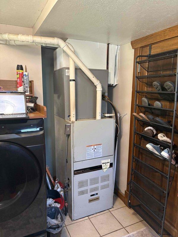 Conducted on-site evaluation for whole-house air conditioning system replacement. Assessed existing outdoor condensing unit of unknown age and indoor furnace system with connected ductwork. Documented current equipment configuration, electrical connections, refrigerant line routing, and overall system condition to provide comprehensive replacement recommendations.