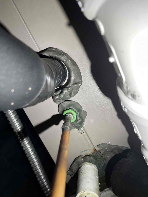 Responded to callback for water accumulation at air handler location. Upon inspection, discovered excessive frost buildup on condensate drain line and deteriorated insulation on refrigerant lines, indicating potential drainage restriction or airflow issue. Documented system conditions with photographs showing ice formation on PVC drain piping and compromised pipe insulation throughout the mechanical assembly.