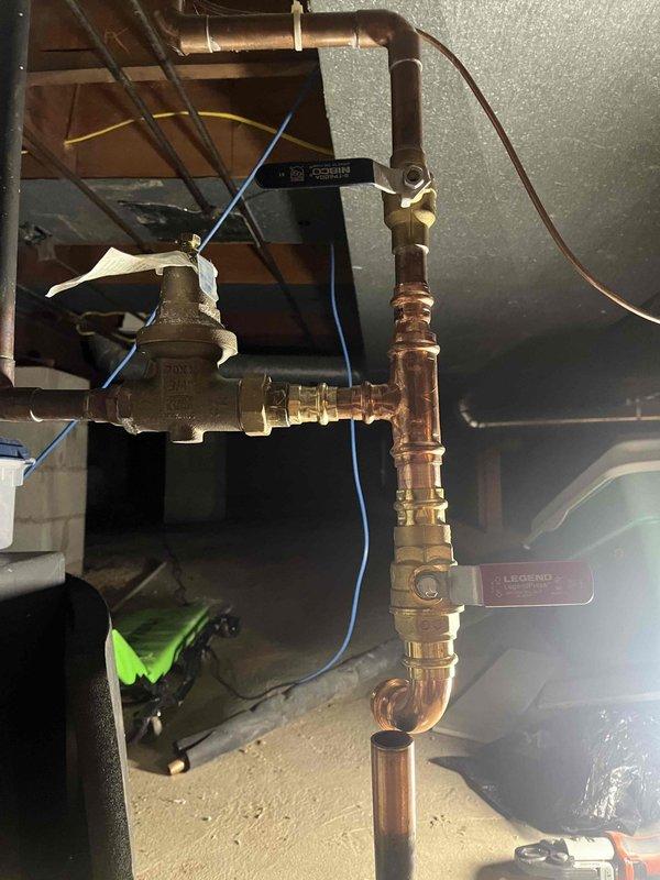 Completed water service line replacement project. Excavated trench through residential lawn to access and replace deteriorated underground water service line from main to structure. Installed new copper piping assembly with proper fittings, shut-off valves, and connections at interior entry point, ensuring code-compliant installation and proper system function.