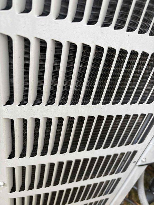 Completed routine cooling maintenance on air handler unit. Member declined relocation of equipment during service. Inspected ventilation grille and exterior mounting hardware, documenting current condition of components showing weathering and oxidation on outdoor fixtures.