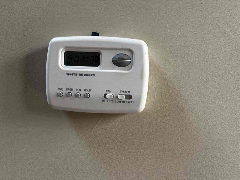 Responded to callback for White-Rodgers thermostat continuously displaying "initializing" screen and failing to call for cooling, resulting in upper level temperature exceeding 80°F. Upon arrival, removed thermostat cover plate and inspected wiring connections at terminal block. Verified all wire terminations including R, Y1, G, C, and remaining terminals were secure and properly seated. Cycled power to thermostat and air handler to clear initialization error. Tested system operation through complete cooling cycle, confirmed proper communication between thermostat and air handler, and verified temperature setpoint response. System now operating normally with cooling functioning as designed.
