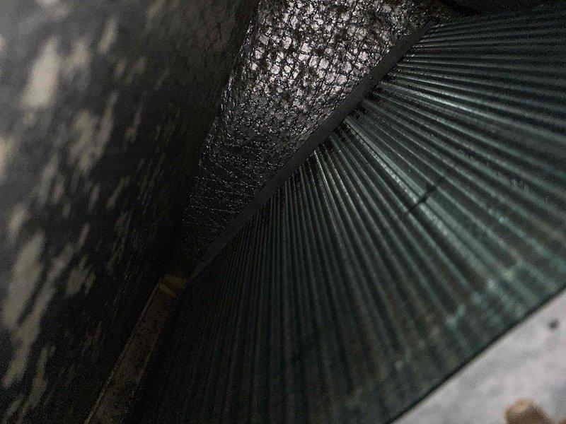 Performed cooling maintenance on club member system with reported temperature imbalance between upper and lower floors. Inspected air handler and ductwork in attic space, documenting flexible duct connections and insulated components. Examined blower wheel assembly, noting dust accumulation on blades and minor corrosion at central mounting hub. Addressed airflow concerns related to upstairs cooling deficiency.