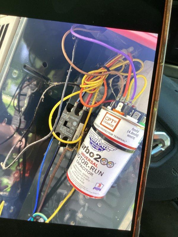 # HVAC Service Report

Responded to no cooling complaint on residential air conditioning system over 10 years old. Upon inspection, identified failed dual run capacitor with severe corrosion on terminals and visible oxidation damage. Capacitor showed brown-orange patina indicating extended exposure to environmental elements and complete failure. Removed defective capacitor from outdoor condensing unit and replaced with new OEM-equivalent dual run capacitor properly rated for system specifications. Verified all electrical connections were secure and torqued to manufacturer standards. Tested system operation and confirmed compressor and condenser fan motor startup with proper amperage draw. System restored to normal cooling operation. Advised customer of system age and recommended monitoring for additional component wear.