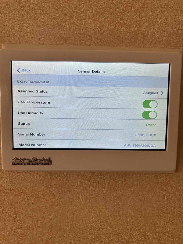 Responded to service call for recently installed American Standard A/C system experiencing inadequate cooling performance and temperature differential between floors. Inspected and verified Z-Wave temperature sensor (Model ZSEN8300AVWOMAA) installed in master bedroom, confirmed sensor is online and properly communicating with UX360 thermostat with both temperature and humidity monitoring enabled. Documented sensor configuration settings and battery condition, photographed thermostat interface showing assigned sensor status and serial numbers for follow-up consultation with manufacturer technical support regarding system performance concerns.