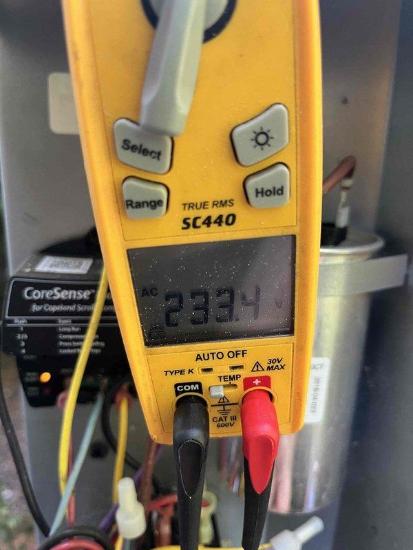 Completed cooling maintenance club visit on air handler system. Member expressed interest in pan treatment service and evaporator coil cleaning. Performed electrical diagnostics using digital multimeter, recording voltage readings of 33.48 VAC to verify proper system operation. Inspected Copeland Scroll compressor monitoring system and associated electrical connections. Documented equipment conditions with photos for service records.