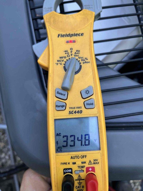 Completed cooling maintenance club visit on air handler system. Member expressed interest in pan treatment service and evaporator coil cleaning. Performed electrical diagnostics using digital multimeter, recording voltage readings of 33.48 VAC to verify proper system operation. Inspected Copeland Scroll compressor monitoring system and associated electrical connections. Documented equipment conditions with photos for service records.