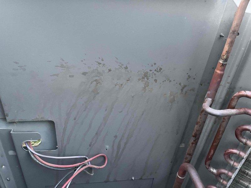 Responded to no-cooling call for upstairs unit. Inspected 8-year-old Rood system with air handler in attic and condenser outdoors. Found condenser operating but upstairs zone not cooling while downstairs unit functioned normally. Accessed outdoor condensing unit and attic air handler for diagnostic evaluation. Documented equipment condition showing normal wear patterns, copper refrigerant lines, and electrical connections. System components including compressor, capacitor, and control wiring were visually inspected for operational assessment.
