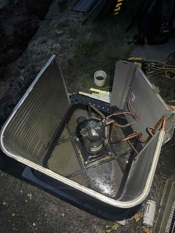 Responded to no-cooling call for upstairs unit. Inspected 8-year-old Rood system with air handler in attic and condenser outdoors. Found condenser operating but upstairs zone not cooling while downstairs unit functioned normally. Accessed outdoor condensing unit and attic air handler for diagnostic evaluation. Documented equipment condition showing normal wear patterns, copper refrigerant lines, and electrical connections. System components including compressor, capacitor, and control wiring were visually inspected for operational assessment.