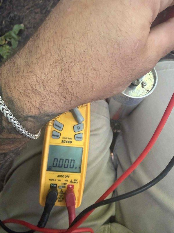 Responded to emergency no-cooling call following power surge on seven to eight year old air conditioning system. Performed diagnostic testing using digital multimeter to measure voltage and capacitance values on system components. Testing revealed failed capacitor with readings outside manufacturer specifications. Replaced defective dual-run capacitor, verified proper microfarad values, and confirmed system returned to normal operation with compressor and condenser fan motor running correctly.