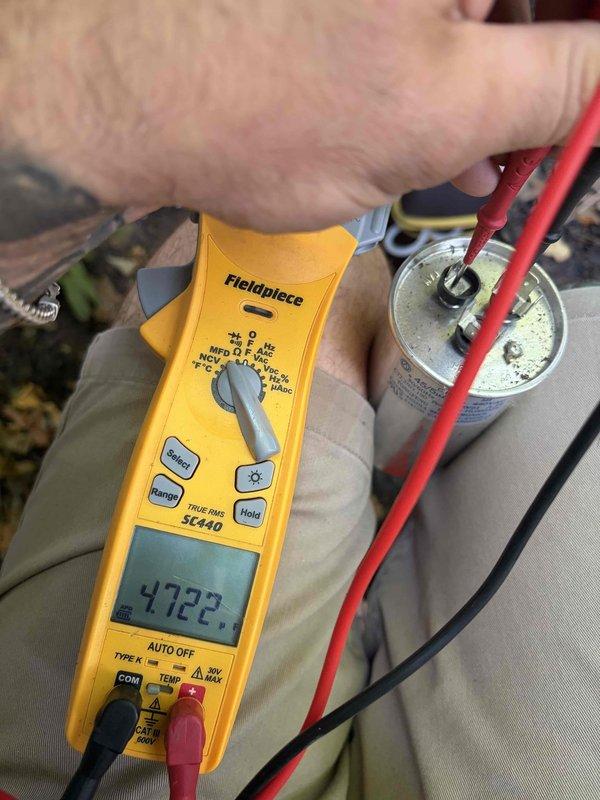 Responded to emergency no-cooling call following power surge on seven to eight year old air conditioning system. Performed diagnostic testing using digital multimeter to measure voltage and capacitance values on system components. Testing revealed failed capacitor with readings outside manufacturer specifications. Replaced defective dual-run capacitor, verified proper microfarad values, and confirmed system returned to normal operation with compressor and condenser fan motor running correctly.