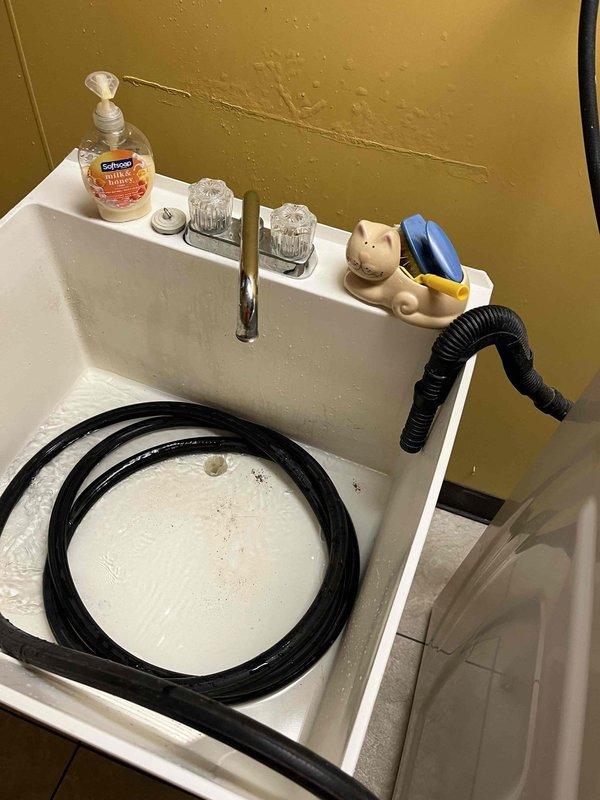 Completed plumbing membership inspection at residential property. Performed visual assessment of utility sink with chrome faucet assembly and acrylic handles, confirming proper operation and drainage. Inspected bathroom facilities including toilet fixture and safety grab bar installation, verified hex tile flooring condition and documented all plumbing components for maintenance records.
