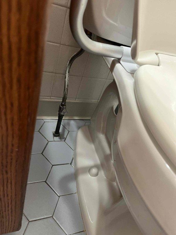 Completed plumbing membership inspection at residential property. Performed visual assessment of utility sink with chrome faucet assembly and acrylic handles, confirming proper operation and drainage. Inspected bathroom facilities including toilet fixture and safety grab bar installation, verified hex tile flooring condition and documented all plumbing components for maintenance records.