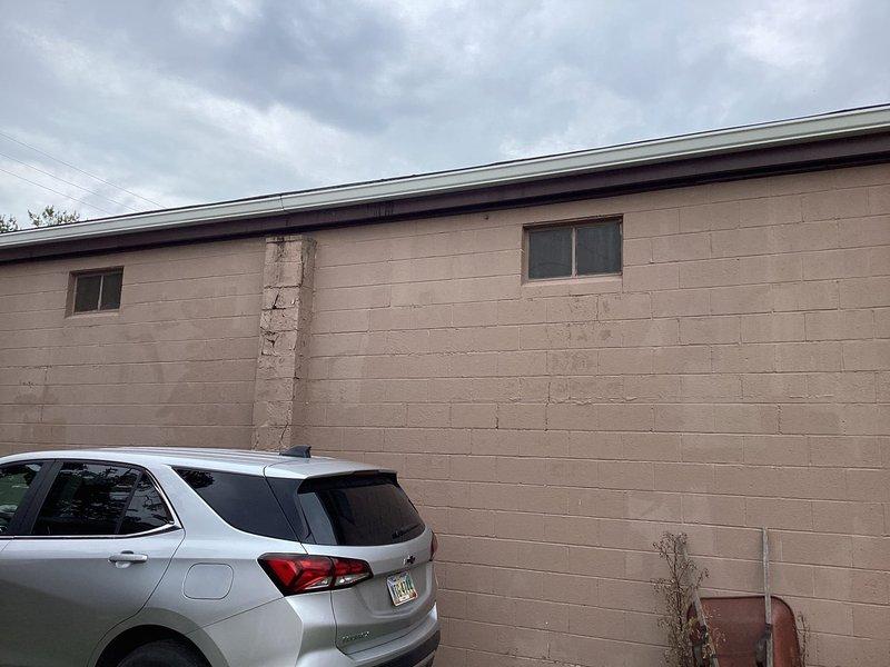 Conducted site evaluation for mini split system installation at 1500-1600 square foot machine shop facility with concrete block construction. Assessed existing cooling infrastructure, including window-mounted AC unit, and evaluated electrical service capacity and optimal placement locations for indoor and outdoor mini split components to provide adequate climate control for the workspace.