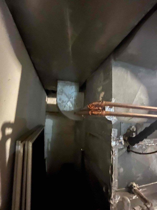 Responded to service call for non-operational heat pump with grounded compressor requiring full system replacement. Assessed existing setup including hydro coil with propane backup heat and determined replacement specifications for new heat pump system without heat strips. Evaluated installation requirements for 120V blower with coil or air handler based on available clearance heights, accounting for existing non-functional wood burner to remain in place and hot water tank available for removal during installation.