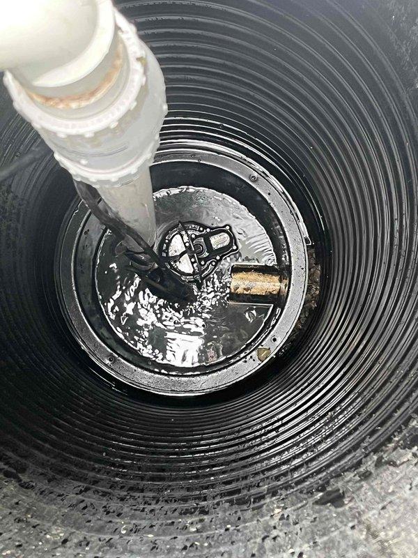 Responded to service call for beeping sump pump system originally installed in 2023. Upon arrival, removed basin cover and inspected pump assembly and float mechanism within the corrugated sump basin. Identified alarm condition indicating potential float switch malfunction or low battery in backup system. Verified pump operation, checked discharge piping connections, and tested float activation sequence. Cleaned debris from basin, reset alarm system, and confirmed proper pump cycling and automatic shutoff functionality before reassembling cover and restoring system to normal operation.
