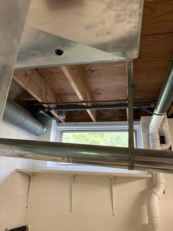 Responded to service call for non-operational air conditioning system in residential property. Customer reported previous contractor quoted expensive blower motor replacement and requested pricing for complete system replacement. Evaluated existing Bryant furnace and air handler installation in basement mechanical room, assessed current equipment condition and ductwork configuration including white PVC supply ducts extending from furnace unit. Provided comprehensive estimate for new HVAC system replacement including equipment specifications and installation requirements based on existing infrastructure and customer needs.