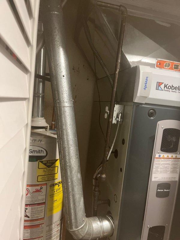Completed full HVAC system installation including new air handler and ductwork in mechanical room. Installed galvanized metal plenum with proper leveling and alignment, routed electrical conduit, and integrated system with existing water heater location. Customer's window units were retrieved for removal as requested.