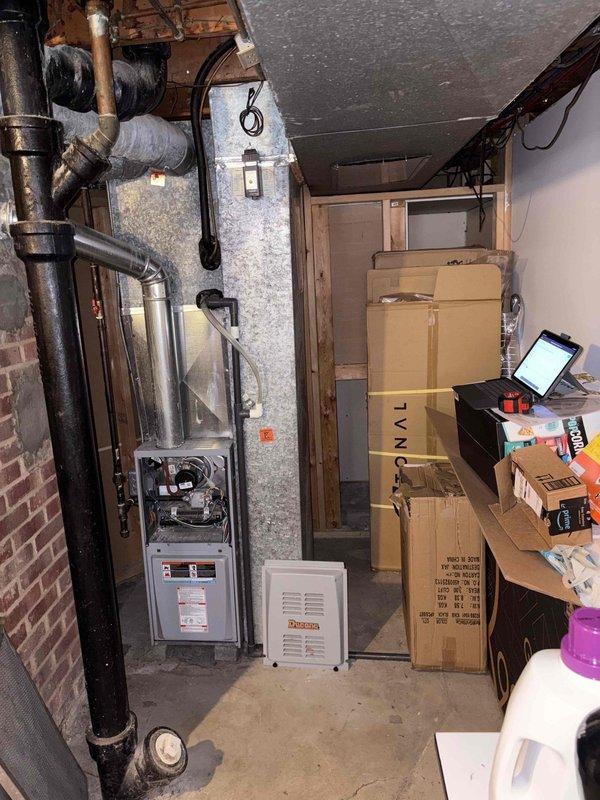 Responded to no-cooling complaint on residential air conditioning system. Upon inspection, found outdoor condensing unit attempting to engage but with no air movement from interior supply registers. Confirmed unit was clicking on at thermostat call but compressor and blower motor were not operating properly. Evaluated aged outdoor unit showing significant weathering and wear, along with basement furnace and ductwork system. Determined system required full replacement due to age and component failure. Provided estimate for complete HVAC system replacement including new outdoor condensing unit and associated equipment.