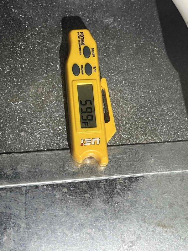 Completed cooling maintenance club member visit on outdoor condensing unit. Removed access panel and performed system diagnostics using digital manifold gauges to verify refrigerant pressures and system performance. Measured supply air temperature at 59.9°F using infrared thermometer, confirming proper cooling operation. Inspected compressor, refrigerant lines, electrical connections, and capacitor. System operating within normal parameters with no immediate repairs required.