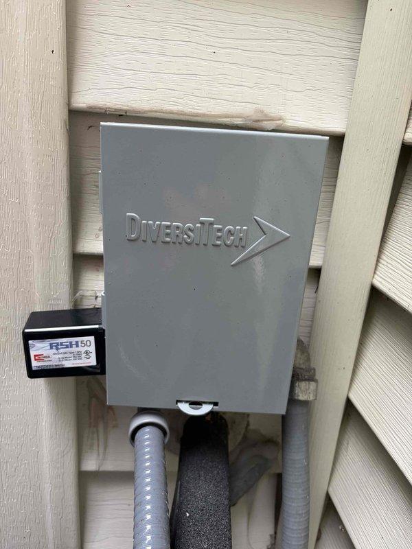 Completed maintenance plan service and installed two DiversiTech surge protection devices on HVAC system. Installed surge protectors in outdoor electrical disconnect boxes, properly wiring units to protect equipment from voltage spikes, with all connections secured to terminal strips and housed in weatherproof enclosures mounted on exterior wall.