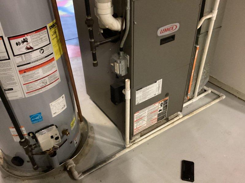 Conducted comprehensive assessment of 19-year-old split HVAC system requiring full replacement. Evaluated existing Lennox furnace unit located in basement and outdoor air conditioning condensing unit mounted on concrete pad adjacent to residence. Both components have reached end of expected service life and require replacement to ensure continued reliable heating and cooling performance.