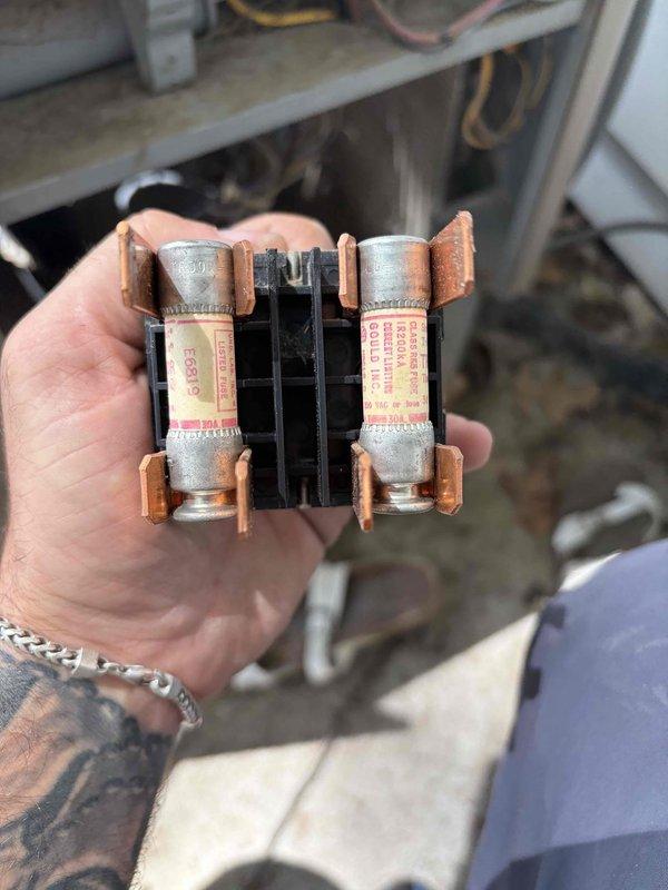 Completed comprehensive AC tune-up on residential air conditioning system of unknown age. Performed standard maintenance procedures including inspection of electrical components, fuse block examination, and exterior disconnect panel assessment. System tested and confirmed operating within normal parameters with no issues identified; electrical connections secure and fuses in good condition, though exterior disconnect panel shows rust deterioration at top seam requiring future monitoring.