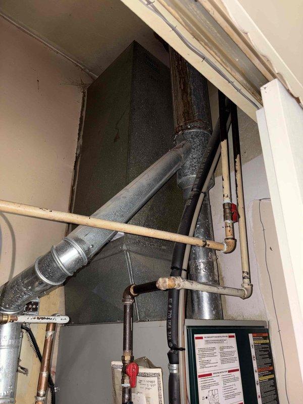 Completed HVAC system evaluation for a 26-year-old installation with recent air conditioning failure. Assessed existing equipment including ductwork, refrigerant lines with deteriorating insulation showing moisture damage, and original Trane thermostat system. Provided comprehensive replacement estimate for aging system that has reached end of serviceable life despite regular maintenance history.