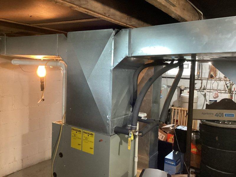Conducted HVAC system evaluation following capacitor replacement that failed to resolve operational issues. Assessed aging outdoor condensing unit showing significant weathering, rust staining on top panel, and overall deterioration consistent with end-of-service-life condition. Evaluated indoor air handler in basement mechanical room and complete system performance. Presented equipment replacement options and buyback programs to address failing system components and prevent complete system failure.