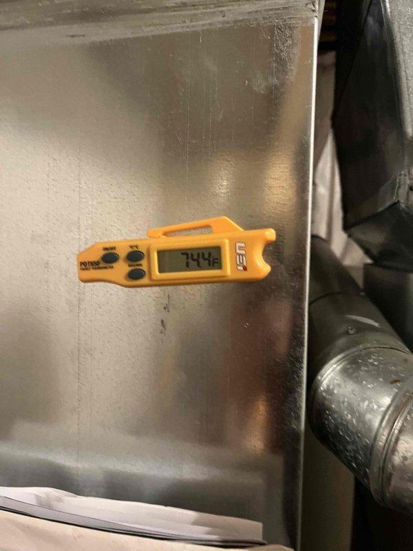 Completed return service call for previously sold blower motor replacement. Verified material was on-site and performed system temperature diagnostics using digital thermometer, recording 74.4°F at unit location. Inspected air filter condition, which showed clean pleated media with no replacement needed at this time.
