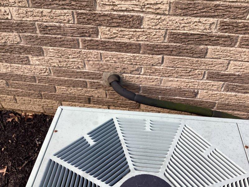 Completed HVAC system evaluation for equipment replacement estimate. Assessed existing outdoor condensing unit positioned against exterior brick wall and documented current ecobee smart thermostat installation with multi-stage wiring configuration including Rc, C, Y1, Y2, O/B, Rh, W1, W2, and PEK terminals to determine compatibility requirements for proposed replacement system.